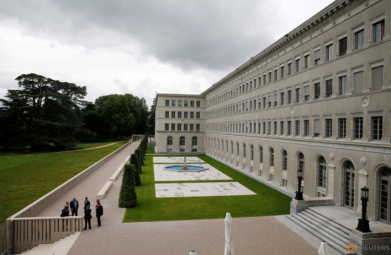 People talk outside the headquarters of the World Trade Organization (WTO) in Geneva, Switzerland, June 3, 2016. 