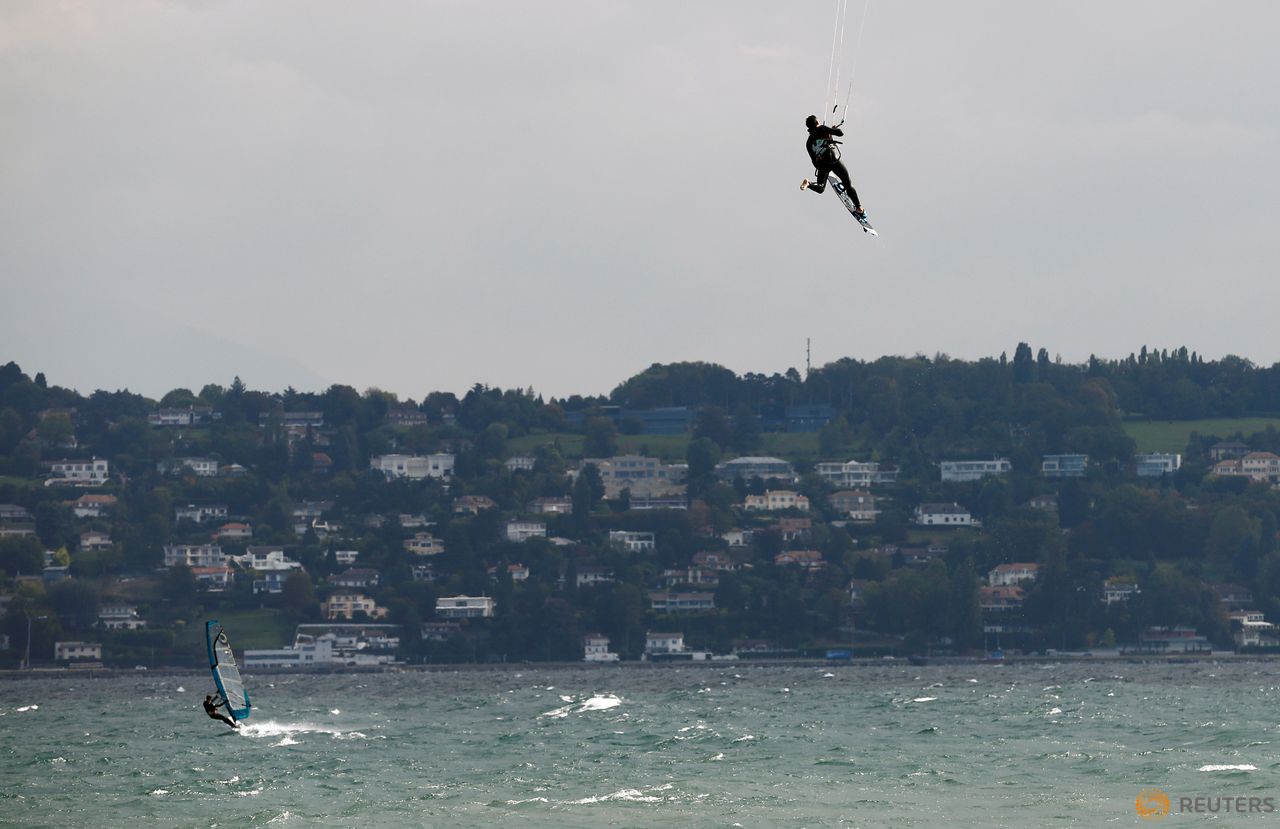 A man kite surfs on a strong northerly windy day on Lake Leman in Geneva, Switzerland October 11, 2016.  