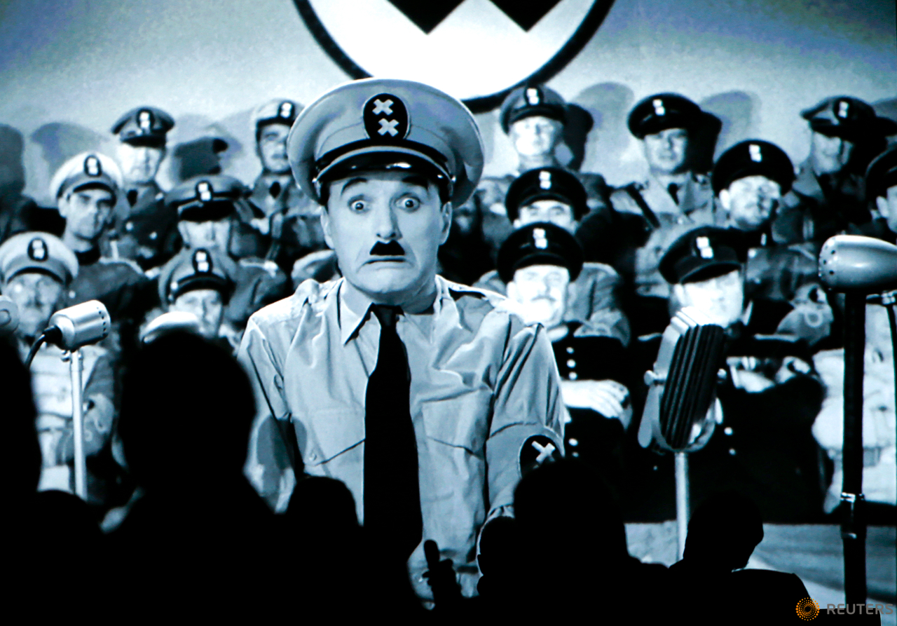Visitors look at an extract of the silent film "The Great Dictator" during a media tour of 'Chaplin's World', an interactive museum celebrating the life and works of comic actor Charlie Chaplin, in Corsier near Vevey, Switzerland, April 16, 2016. The museum is set on the vast estate of Manoir de Ban, where Chaplin spent the last 25 years of his life until his death.   