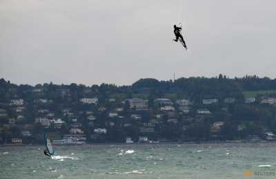 A man kite surfs on a strong northerly windy day on Lake Leman in Geneva, Switzerland October 11, 2016. A man kite surfs on a strong northerly windy day on Lake Leman in Geneva, Switzerland October 11, 2016.