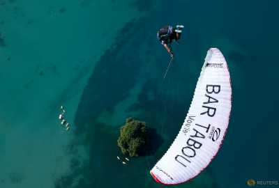 Morane Montavon, pilot of the Swiss Acro League, performs an infinity tumbling maneuver while paragliding above Lake Leman during a training session before the Acroshow competition in Villeneuve, Switzerland, August 17, 2016. Morane Montavon, pilot of the Swiss Acro League, performs an infinity tumbling maneuver while paragliding above Lake Leman during a training session before the Acroshow competition in Villeneuve, Switzerland, August 17, 2016.