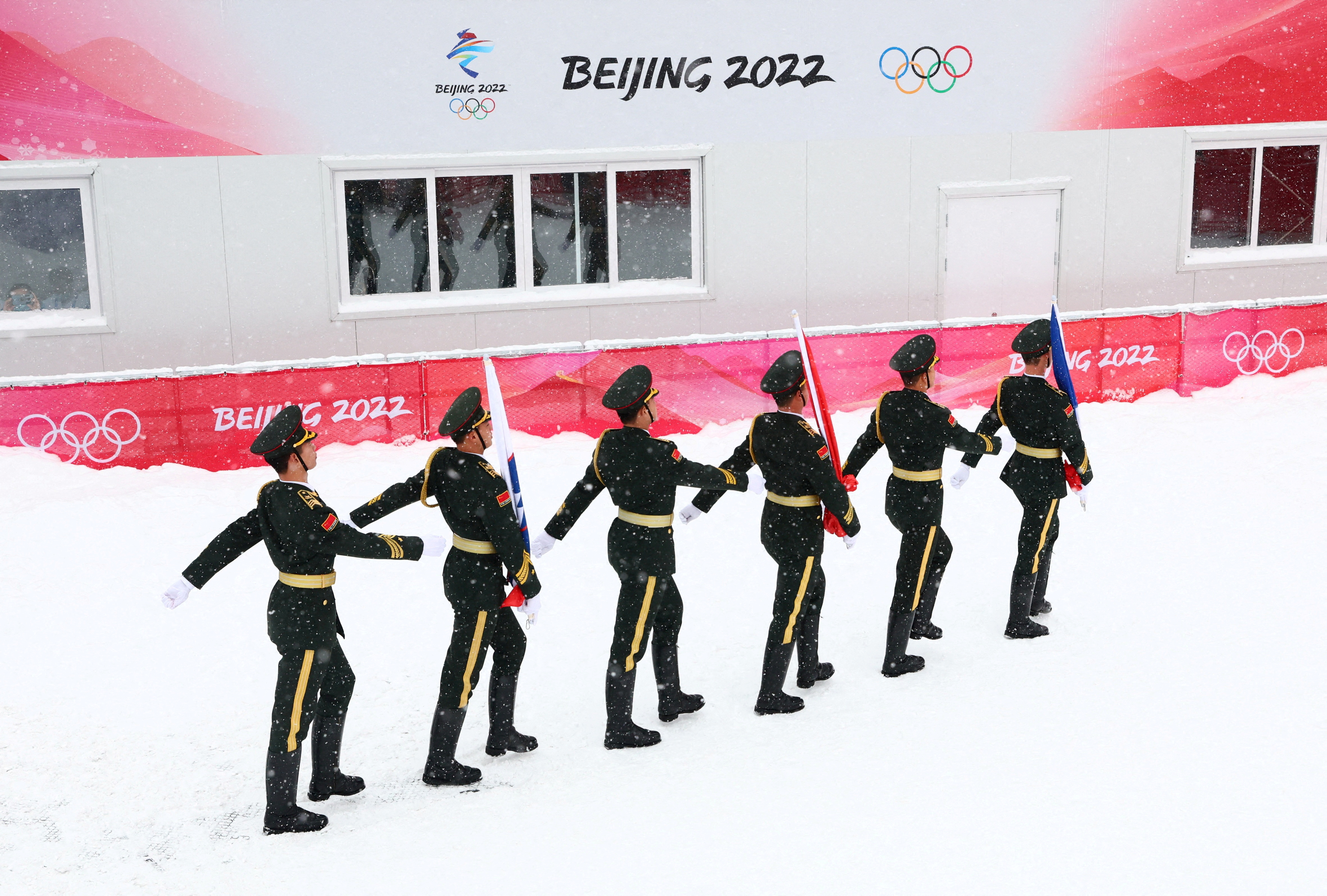 2022 Beijing Olympics - Victory Ceremony - Alpine Skiing - Men's Giant Slalom - National Alpine Skiing Centre, Yanqing district, Beijing, China - February 13, 2022. Members of China's paramilitary forces march with the national flags of Switzerland, Slovenia and France. REUTERS/Denis Balibouse     SEARCH "OLYMPICS DAY 10" FOR BEIJING 2022 WINTER OLYMPICS EDITOR'S CHOICE, SEARCH "REUTERS OLYMPICS TOPIX" FOR ALL EDITOR'S CHOICE PICTURES    TPX IMAGES OF THE DAY   
