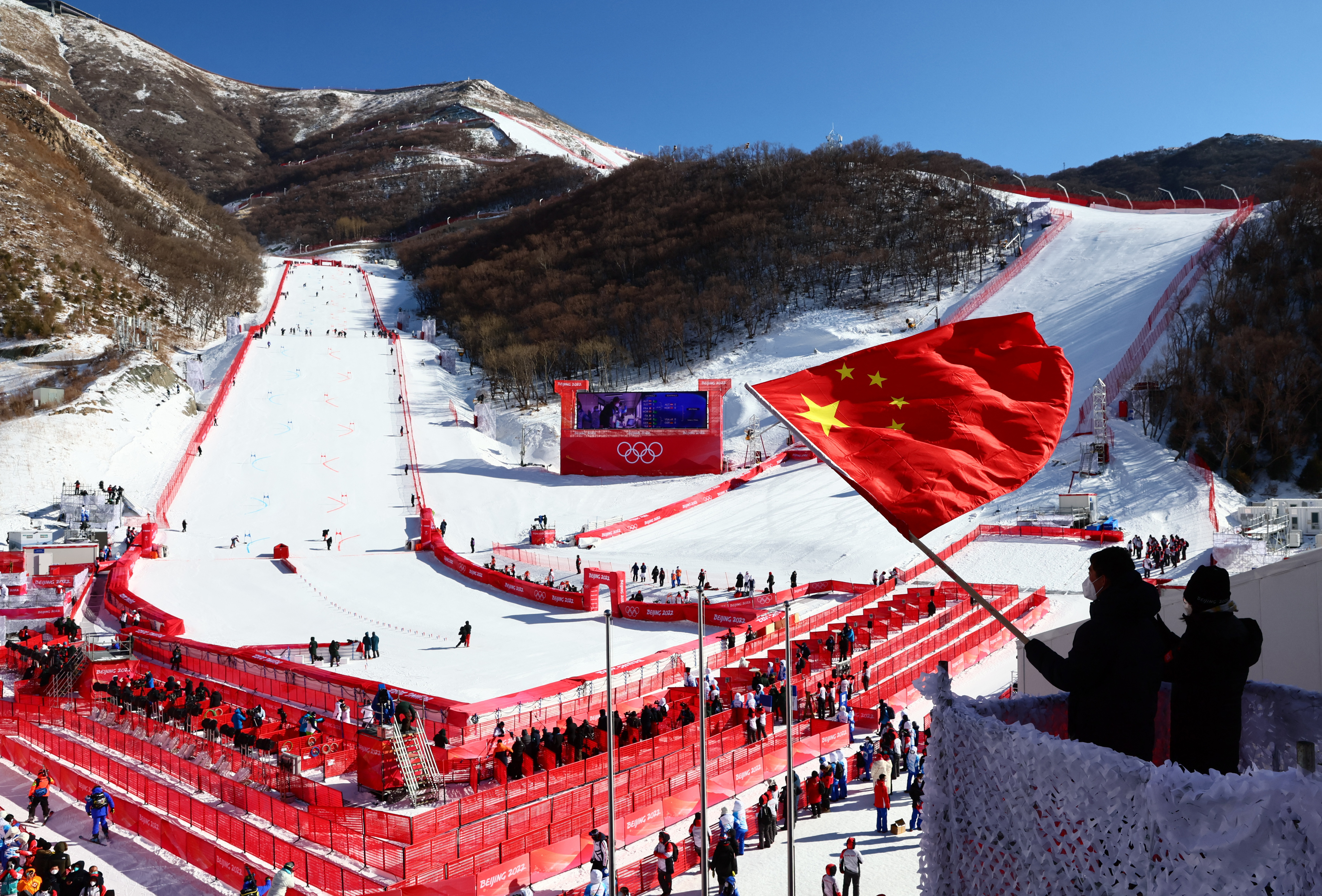 2022 Beijing Olympics - Alpine Skiing - Mixed Team Parallel 1/4 Finals - National Alpine Skiing Centre, Yanqing district, Beijing, China - February 20, 2022. A person waves a Chinese national flag after the event. REUTERS/Denis Balibouse
