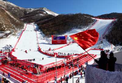 2022 Beijing Olympics - Alpine Skiing - Mixed Team Parallel 1/4 Finals - National Alpine Skiing Centre, Yanqing district, Beijing, China - February 20, 2022. A person waves a Chinese national flag after the event. REUTERS/Denis Balibouse